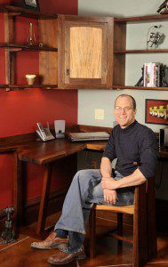 A man sitting in front of a desk.