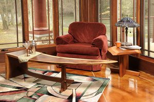 A living room with a couch, chair and coffee table.