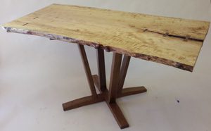 A table with two legs and a wooden top.